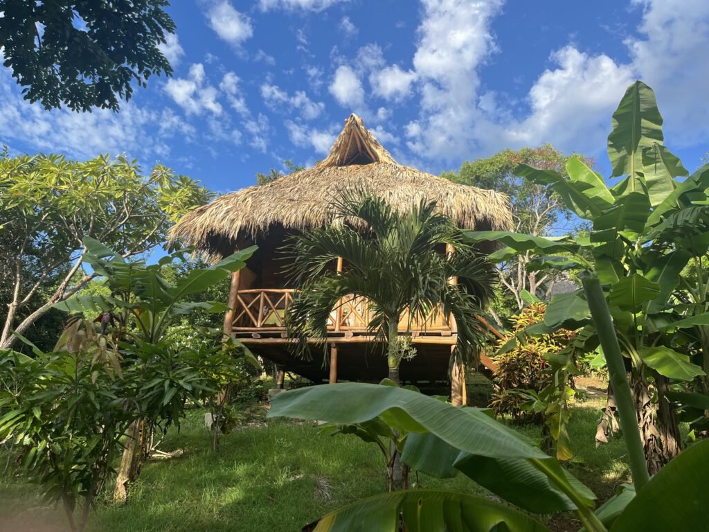 Wooden bungalow nestled in a tropical environment, providing a peaceful retreat for yoga teacher training in Central America