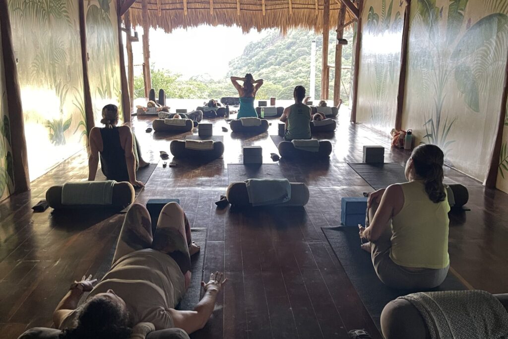 Relaxing yoga class overlooking the ocean, offering a peaceful and rejuvenating atmosphere for yoga teacher training in Central America.