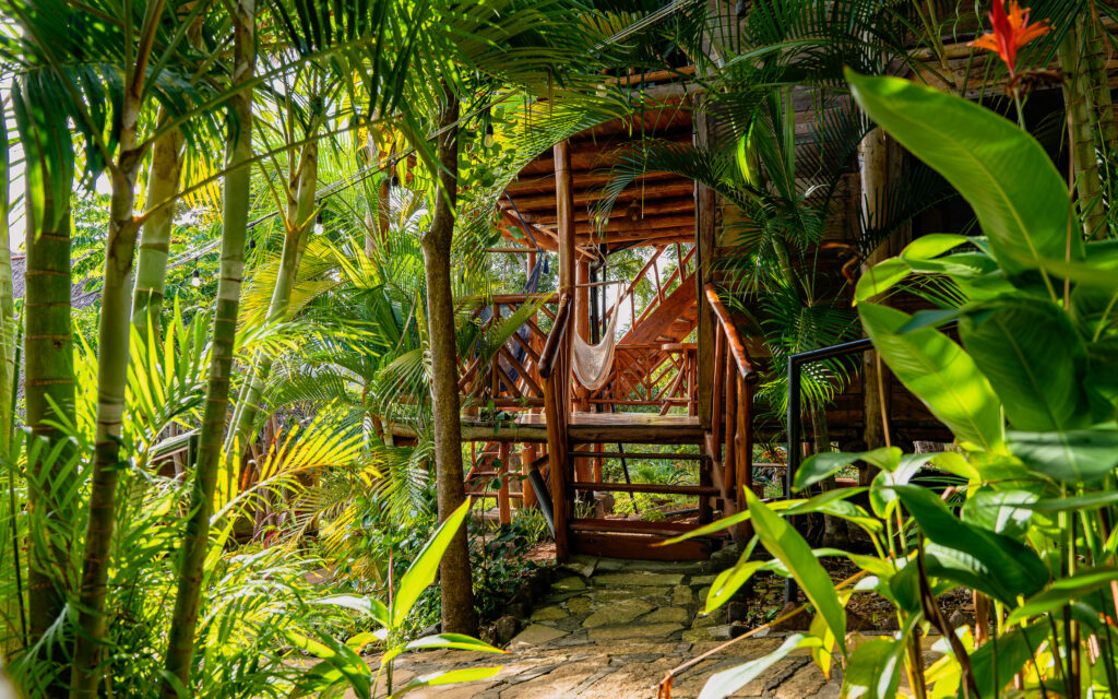 Tropical wooden bungalow in the middle of a garden