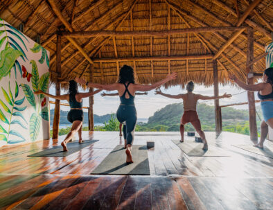 woman doing yoga on ocean view yoga deck