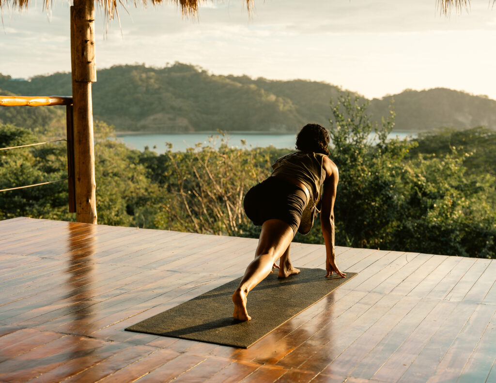 woman doing yoga with ocean view